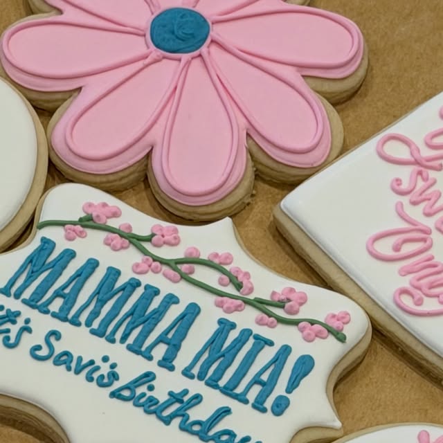 Pink flower cookies and a Mamma Mia plaque for Savi’s birthday, September 11, 2026.