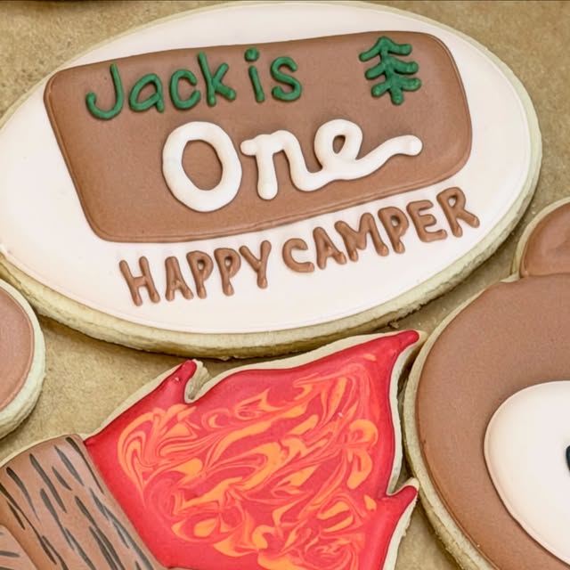 Jack is One Happy Camper first birthday cookies: plaque, campfire, and bear, August 17, 2026.